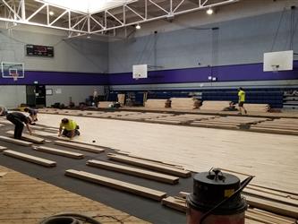 Workers putting in the new wood floor.